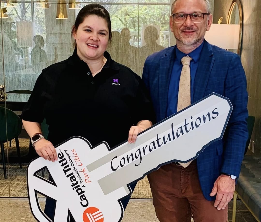 Lorne McMillan with client Tamara holding a Capital Title congratulations key on closing day