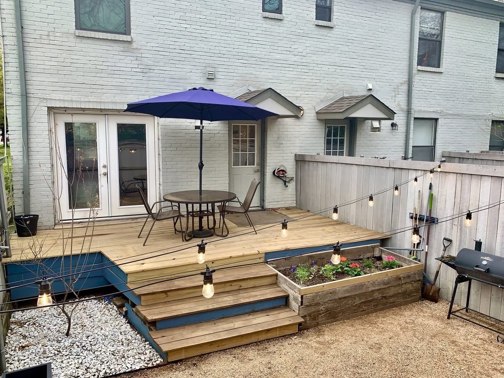 Deck patio with string lights and outdoor dining